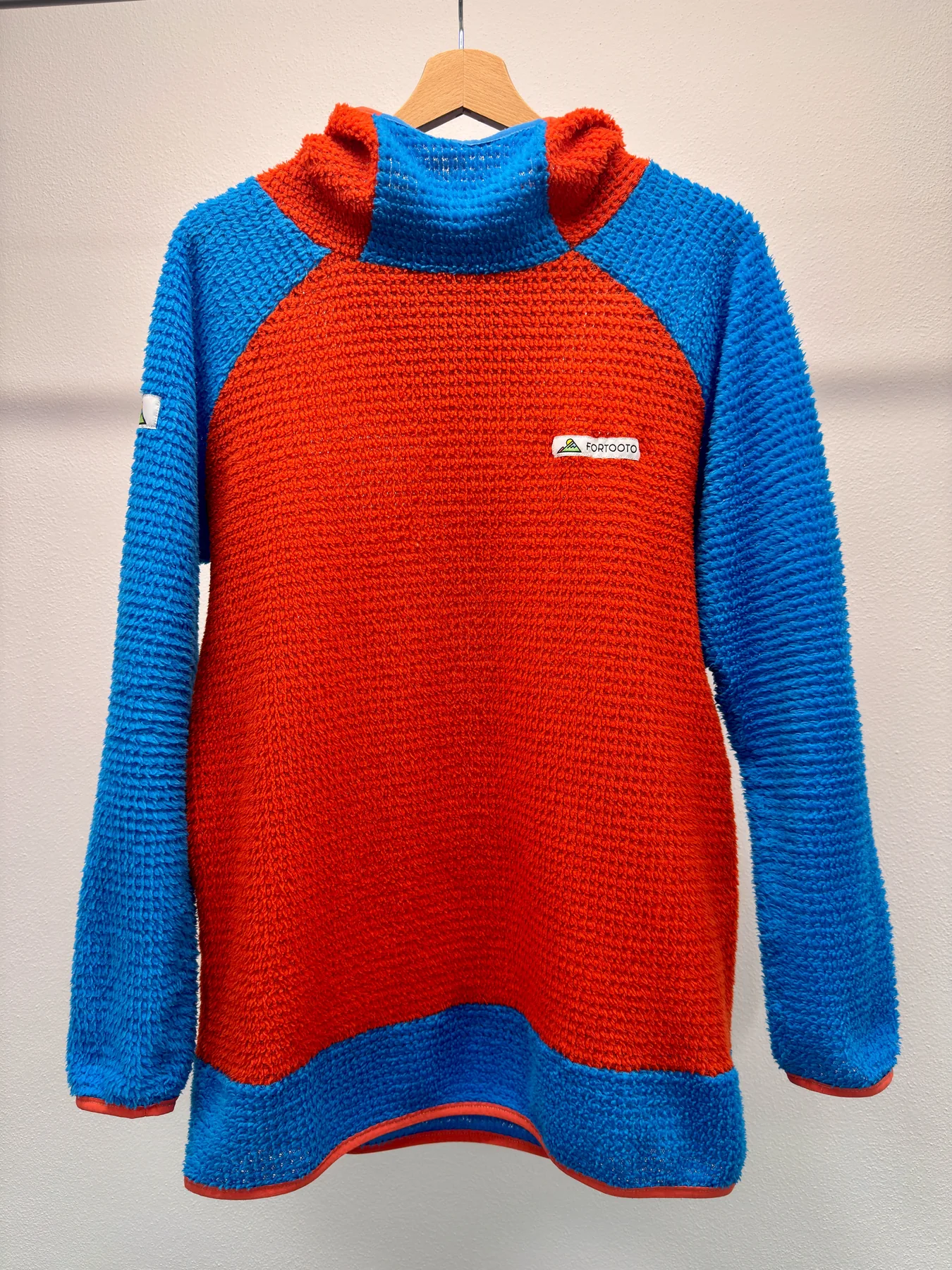 Front view of a custom FORTOOTO Alpha Direct hoodie in orange and blue