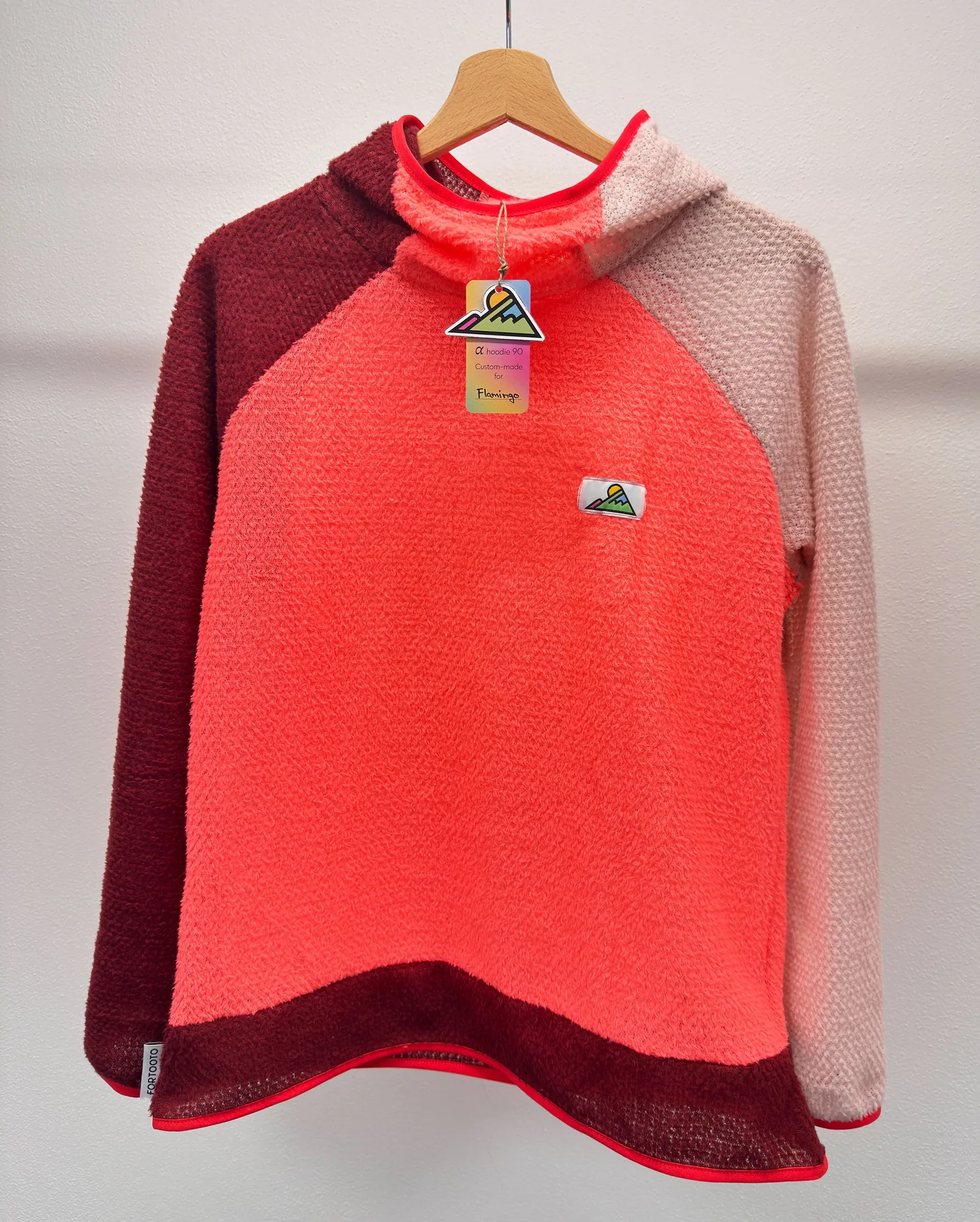 Front view of Flamingo, a three-color FORTOOTO Alpha 90 hoodie