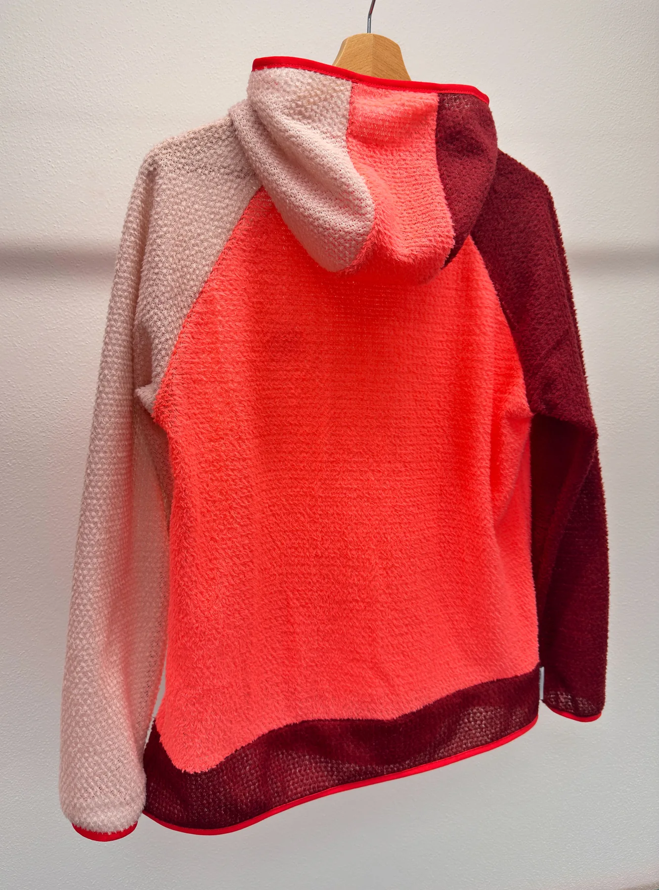 Back view of Flamingo Alpha 90 hoodie showing the three-color panel layout