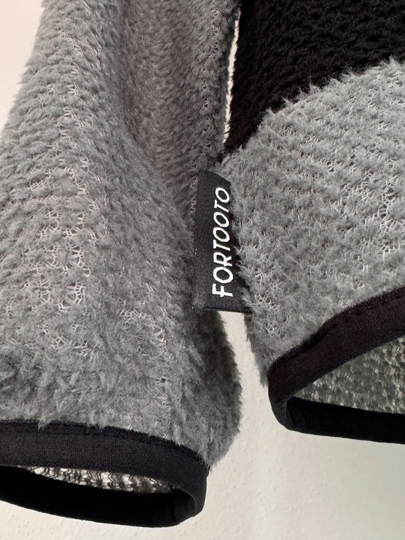 Label and hem detail of Uragan Alpha 90 hoodie