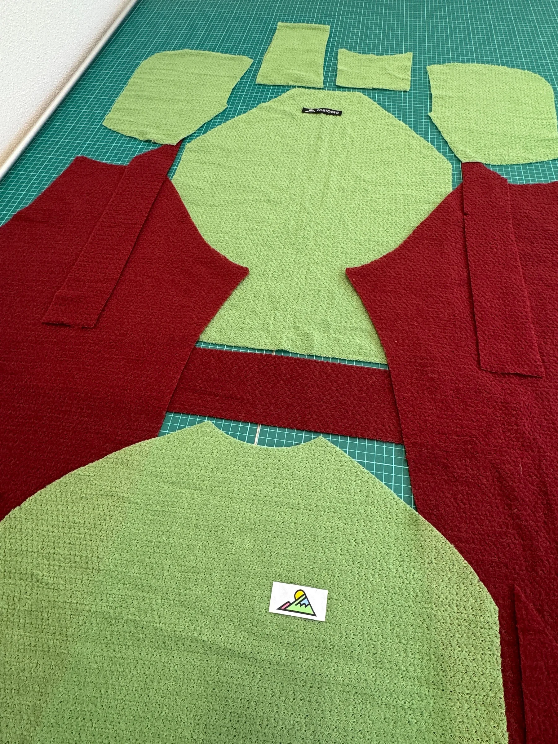 Custom hoodie fabric pieces laid out for assembly